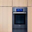 Connected kitchen with a smart refrigerator and oven, subtly lit