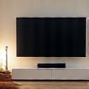 Modern media console with hidden smart audio system and large flat-screen TV