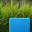 Smart irrigation system controller next to a lush, green garden