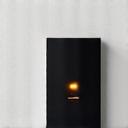 Smart light switch installed elegantly in a modern wall, glowing softly
